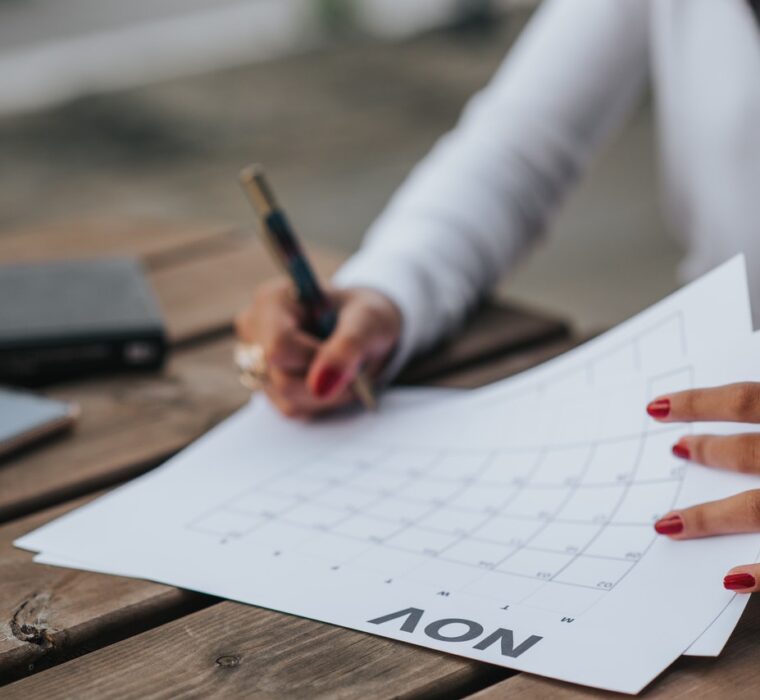 Mulher consultando e fazendo anotações do prazo do contrato de locação em um calendário